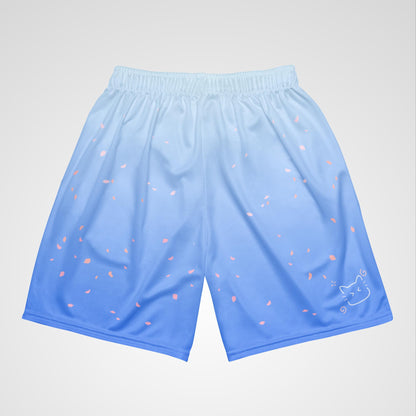 Top view of blue shorts with floral and cat designs on a light gray background