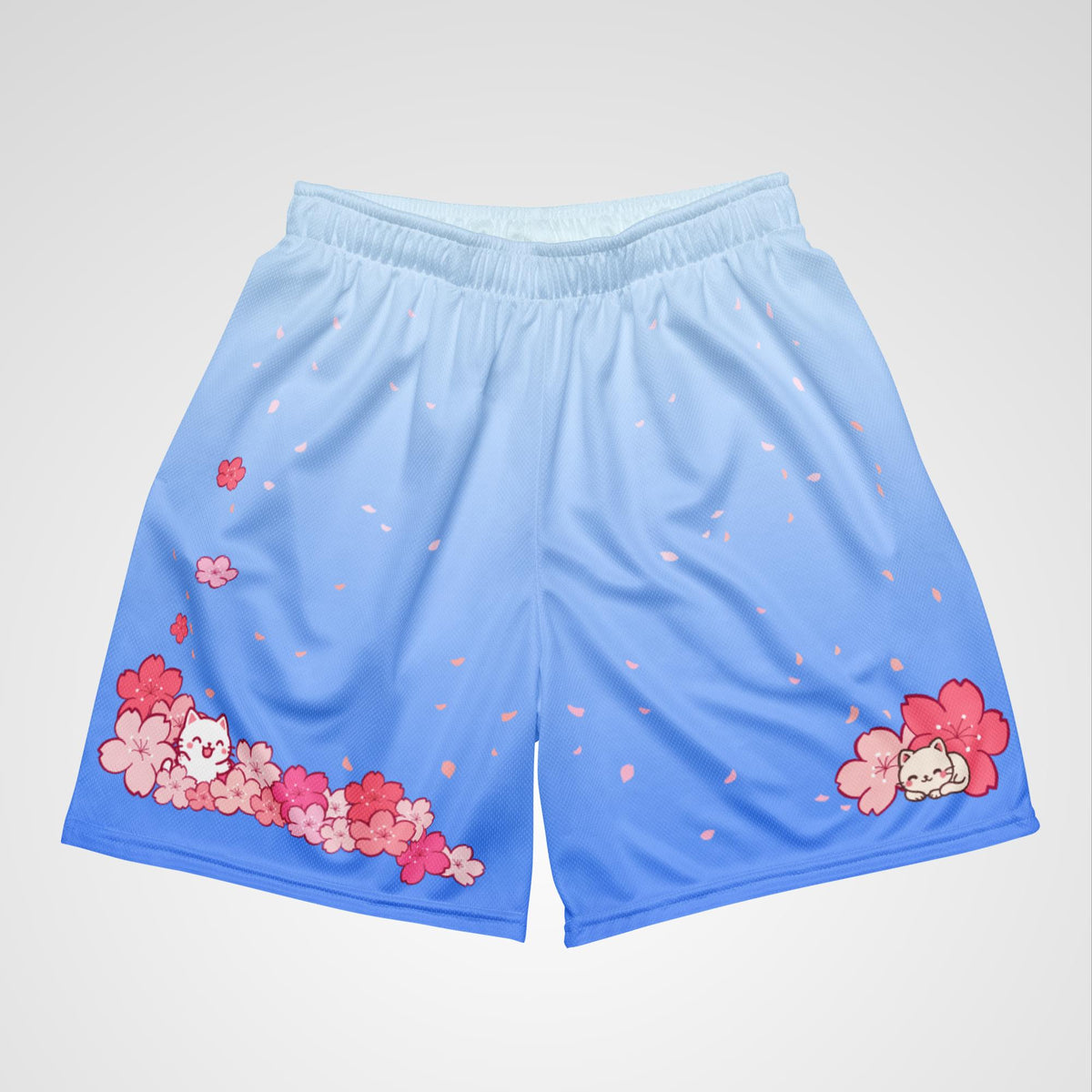 Front top view of blue shorts with floral and cat designs on a light gray background