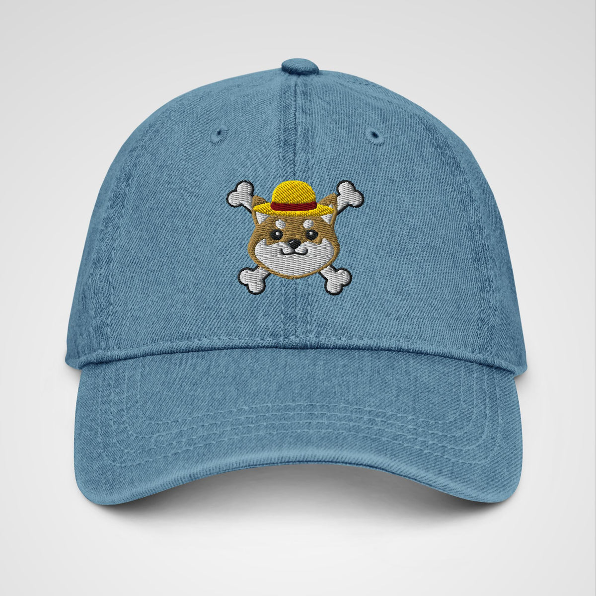 Blue denim hat featuring embroidered logo of a shiba inu x One Piece Luffy's hat and crossbones